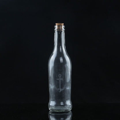 NeverBite form Chewy Chums packaging of a clear glass bottle with an anchor engraving on a black background